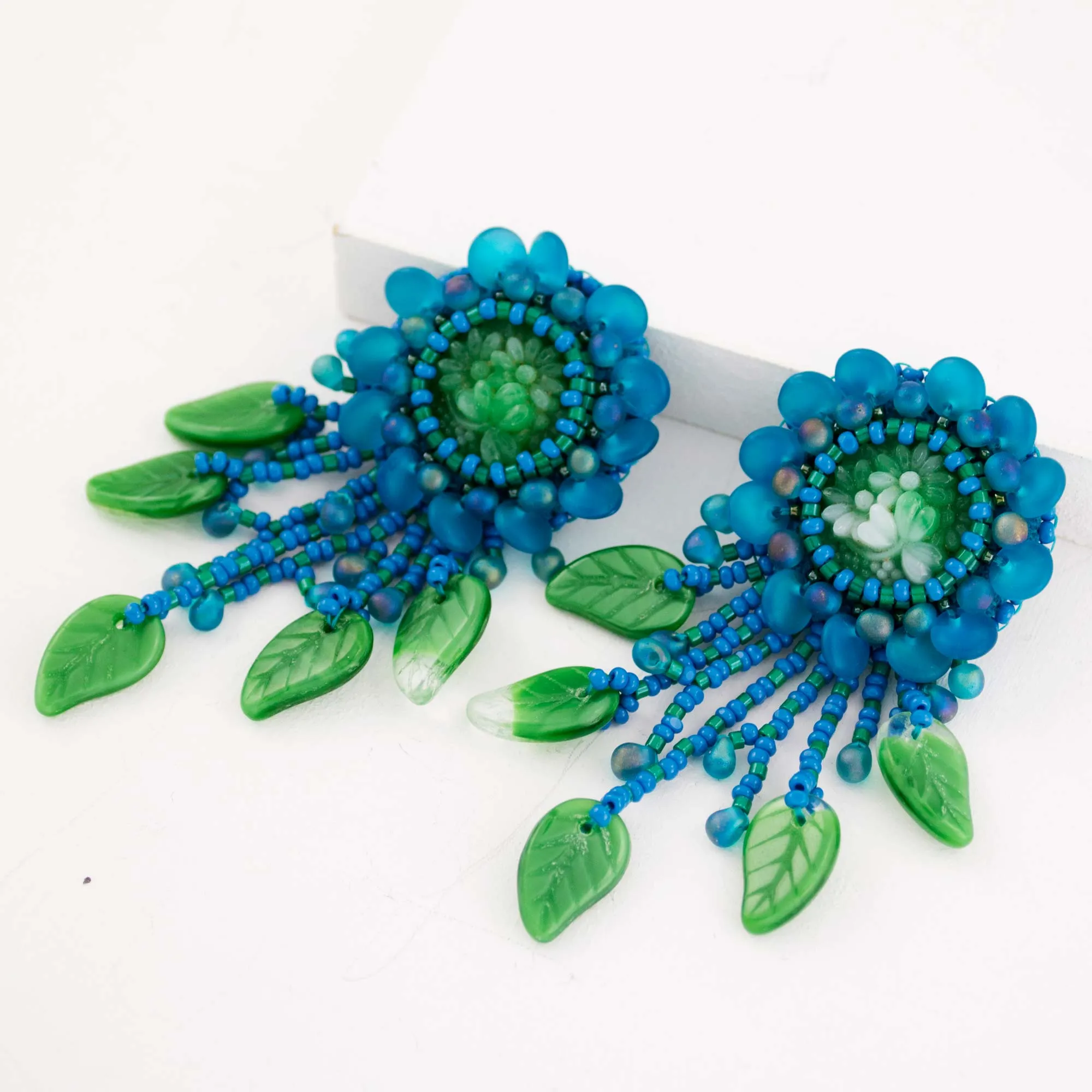 Teal green beaded statement earrings with vintage cabochon