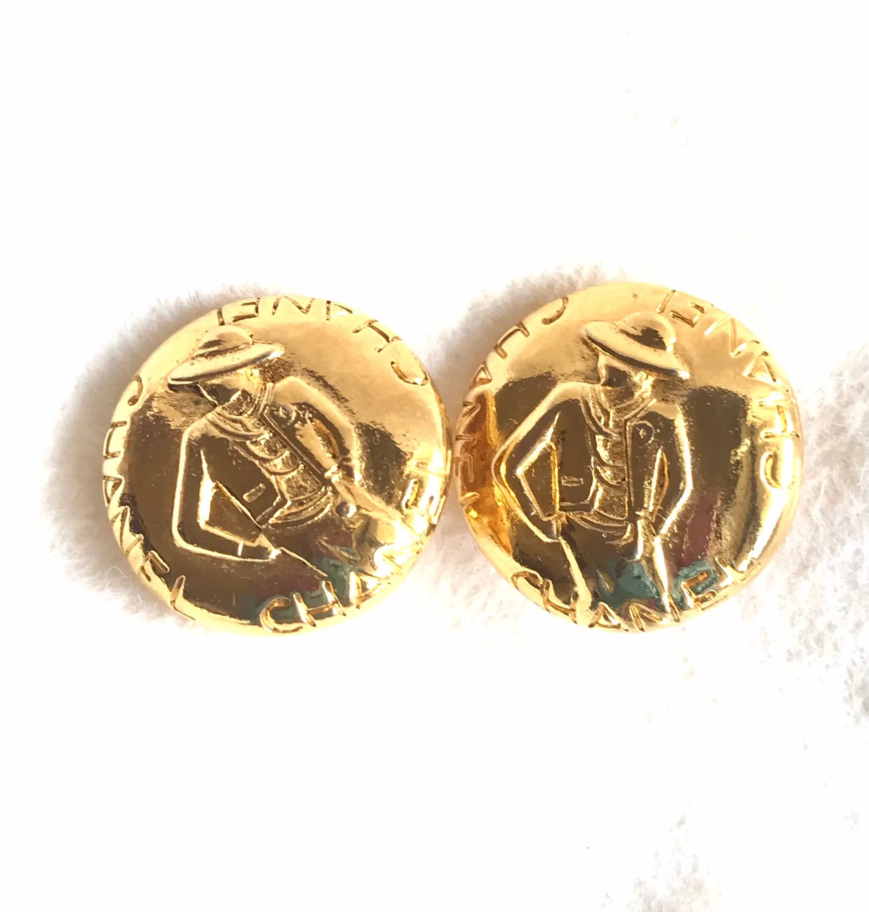 Vintage CHANEL gold tone round earrings with mademoiselle figure. Classic vintage Chanel jewelry. 0406011